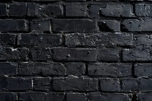 Eski tuğla duvarın resmi siyah renge boyanmış. Yakın plan. Arkaplan veya haritalama için arkaplan dokusu