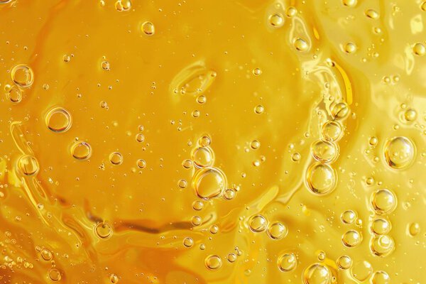 Photo of Natural resource sunflower oil substance texture close up. Food photo for backdrops or recipes