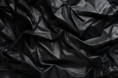 Siyah selofan çöp torbası dokusunun işlenmiş kolajı. Pankart, arkaplan veya 3B haritalama için doku