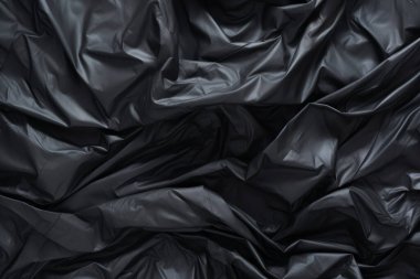 Siyah selofan çöp torbası dokusunun işlenmiş kolajı. Pankart, arkaplan veya 3B haritalama için doku