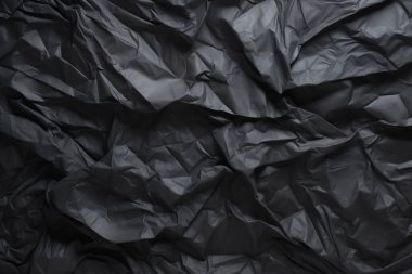 Siyah selofan çöp torbası dokusunun işlenmiş kolajı. Pankart, arkaplan veya 3B haritalama için doku