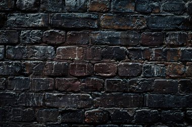 Eski getto siyah tuğla duvarının fotoğrafı. Arkaplan veya haritalama için arkaplan dokusu