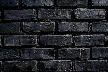 Eski tuğla duvarın resmi siyah renge boyanmış. Yakın plan. Arkaplan veya haritalama için arkaplan dokusu