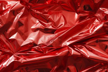 İşlenmiş kırmızı plastik selofan yüzey dokusu kolajı. Pankart, arkaplan veya 3B haritalama için doku