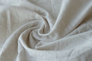 Arka plan olarak beyaz renkli gri tekstil peçetesi. Katlanmış dekoratif mutfak pamuğu havlusu kapat.