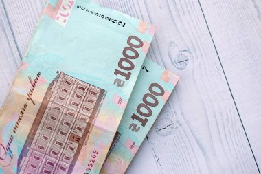 Beyaz ahşap masa üzerinde modern tasarımı olan büyük miktarda Ukrayna yapımı 100 Hryvnia para faturası. Finansal konsept, iş ücretleri