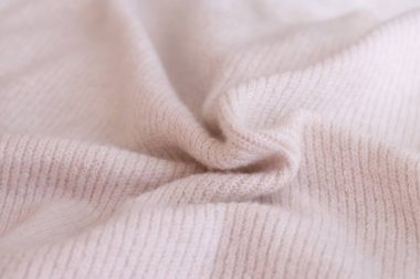 Örülmüş pastel pembe süveter dokusu, yakın çekim bej pembe örgü kumaş dokusu.