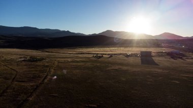 Sunset over farm surrounded by fields in Nevada
