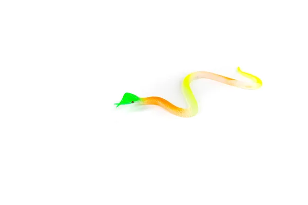 Small toy snake slithers across white background