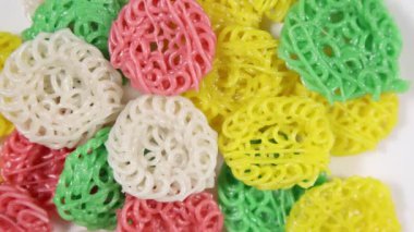 Pişmemiş çok renkli tapyoka krakerleri saat yönünde dönüyor - alanın sığ derinliği.