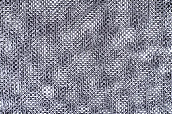 Black mesh fabric texture over white background with moire effect
