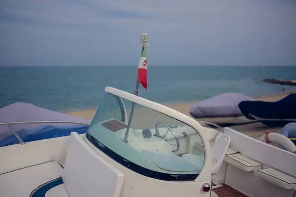 stock image Boat windshield with a small Italian flag on top. Boat close-up against the background of the sea.