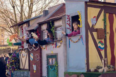 Eisenach, Germany - 09 Mar 2024: Carnaval in German city. A holiday dedicated to saying goodbye to winter and welcoming spring. Beautiful people in creative costumes with animals walk down the street. clipart