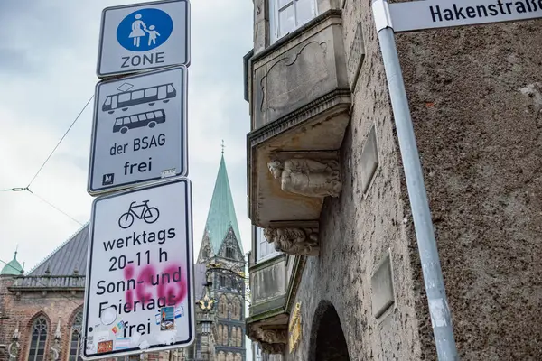 stock image Bremen, Germany - 11.03.2023: Street of a big city, road signs and old house on front and an ancient cathedral in the Gothic style on background.