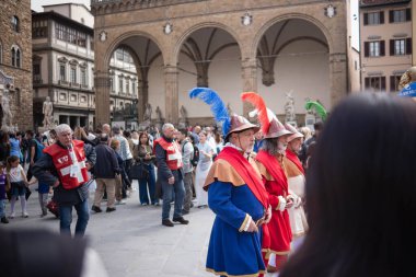Floransa, İtalya, 04.16.2025: Bir İtalyan şehrinin ortasında şövalye alayı. Floransa 'da bir meydanda bayraklı, tarihi kostümlü bir geçit töreni yapılıyor..