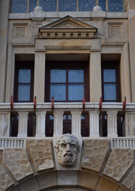 Tarihi balkon cephesi, detaylı taş heykeller, süslemeler ve zarif sütunlarla klasik mimariyi gözler önüne seriyor. Dış özellikler, Avrupa kültür mirası.