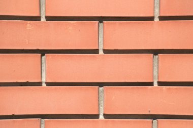Tam kare kırmızı tuğla duvar, dikdörtgen yatay desen ve arka plan. Toprak tuğla duvar kağıdı, çimento eklemleri, arka plan ya da inşaat projesi. Duvarcılık, mimarlık, kırsal ve sağlam duvar dokusuna sahip şehir tasarımı..