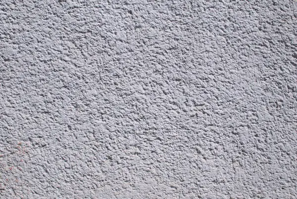 Gri bir duvarın arka planının kabataslak, kumlu bir dokusu var. Beton yüzey doğal düzensizlikleri gösteriyor, bu da onu arka planlar, mimari sunumlar veya inşaatla ilgili tasarım projeleri için ideal kılıyor.. 