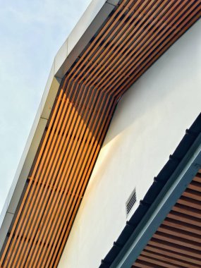 Ahşap çatallar ve havalandırma ızgarası olan modern bir tavan manzarası..