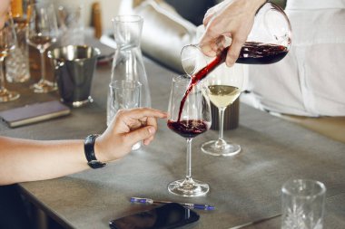 Çalışanlar için alkollü içecekler eğitiminde şarap sürahisine şarap dolduran şarap garsonu. Dünya çapında sertifika almak için sınavı tamamlamaya hazırlanıyorum. Sommelier Okulu.