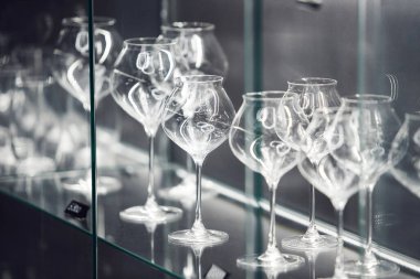 Şık raflarda sergilenen kristal şarap kadehleri