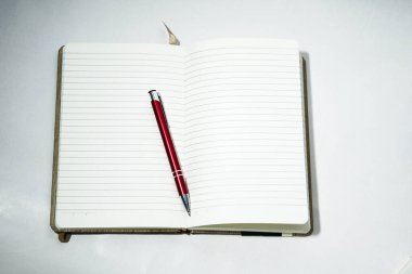 Beyaz arkaplan üzerinde kırmızı kalem açık kağıt defter.