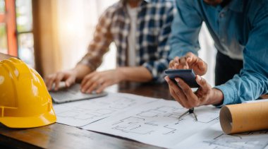 Engineer Teamwork Meeting, Drawing working on blueprint meeting for project working with partner on model building at company office. Asian industry professional team