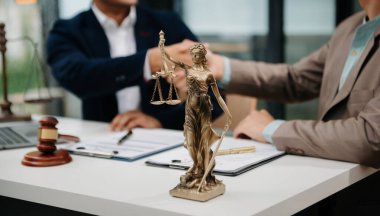 Male lawyer in the office with brass scale on wooden table. justice and law concept 