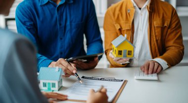 Considering buying a home, investing in real estate. Broker signs a sales agreement. agent, lease agreement, successful deal in office