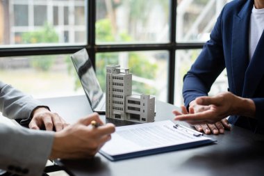 Sales giving male customer signing sales contract, woman and man doing business in office, business concept and contract signing.