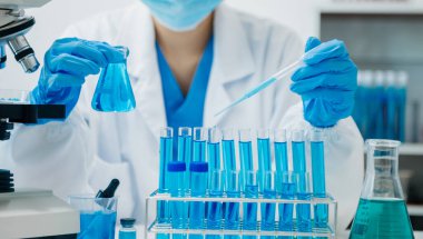 Modern tıbbi araştırma laboratuvarı. Kadın bilim adamı mikro pipetlerle çalışıyor biyokimyasal örnekleri analiz ediyor, tıp için ileri bilim kimya laboratuvarı.