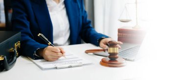 justice and law concept.Male judge in a courtroom on wooden table and Counselor or Male lawyer working in office. 