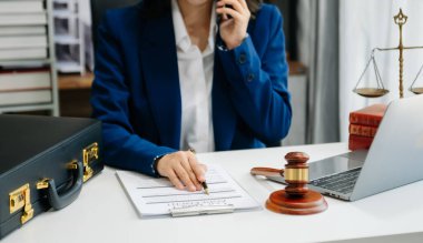 justice and law concept.Male judge in a courtroom on wooden table and Counselor or Male lawyer working in office. 