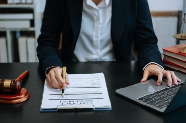 Adalet ve hukuk kavramı. Tahta masadaki bir mahkeme salonunda erkek yargıç ve avukat veya erkek avukat çalışıyor. 