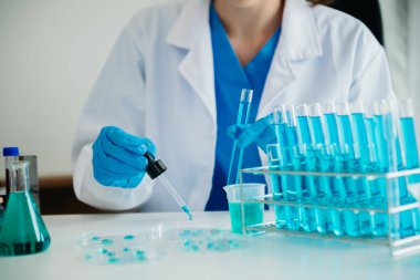 Modern tıbbi araştırma laboratuvarı. Kadın bilim adamı mikro pipetlerle çalışıyor biyokimyasal örnekleri analiz ediyor, ileri bilim kimya laboratuvarı