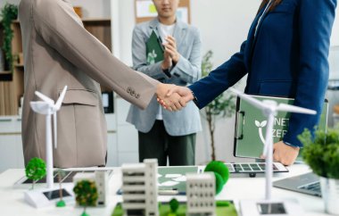 Business people having consultation about wind energy at company office. Business team discussing about windmill and alternative green energy. Executive meeting 