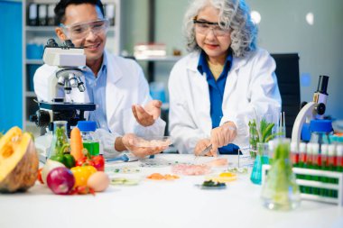 Team of scientists examining food samples in a lab with microscopes. Perfect for themes of food science, biotechnology, and nutrition research teamwork