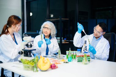 Team of scientists examining food samples in a lab with microscopes. Perfect for themes of food science, biotechnology, and nutrition research teamwork