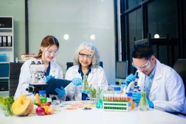Team of scientists examining food samples in a lab with microscopes. Perfect for themes of food science, biotechnology, and nutrition research teamwork