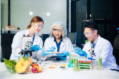 Team of scientists examining food samples in a lab with microscopes. Perfect for themes of food science, biotechnology, and nutrition research teamwork