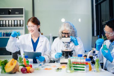 Team of scientists examining food samples in a lab with microscopes. Perfect for themes of food science, biotechnology, and nutrition research teamwork
