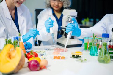 Team of scientists examining food samples in a lab with microscopes. Perfect for themes of food science, biotechnology, and nutrition research teamwork