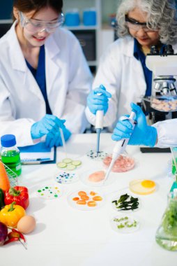 Team of scientists examining food samples in a lab with microscopes. Perfect for themes of food science, biotechnology, and nutrition research teamwork