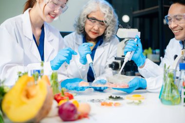 Team of scientists examining food samples in a lab with microscopes. Perfect for themes of food science, biotechnology, and nutrition research teamwork
