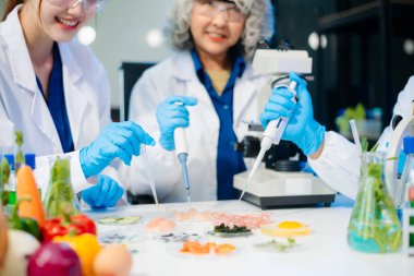 Team of scientists examining food samples in a lab with microscopes. Perfect for themes of food science, biotechnology, and nutrition research teamwork