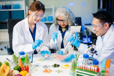 Team of scientists examining food samples in a lab with microscopes. Perfect for themes of food science, biotechnology, and nutrition research teamwork