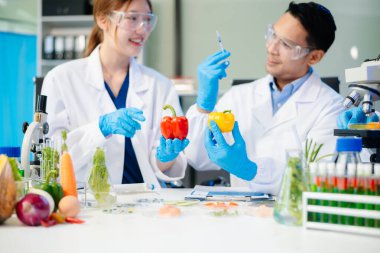 Team of scientists examining food samples in a lab with microscopes. Perfect for themes of food science, biotechnology, and nutrition research teamwork