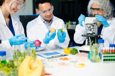Team of scientists examining food samples in a lab with microscopes. Perfect for themes of food science, biotechnology, and nutrition research teamwork