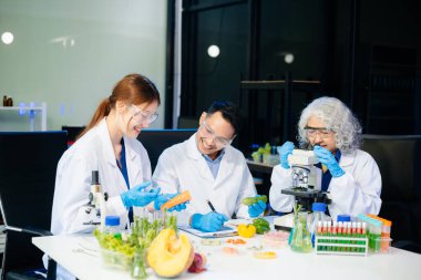 Team of scientists examining food samples in a lab with microscopes. Perfect for themes of food science, biotechnology, and nutrition research teamwork
