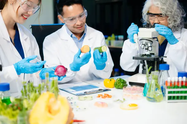 Team of scientists examining food samples in a lab with microscopes. Perfect for themes of food science, biotechnology, and nutrition research teamwork